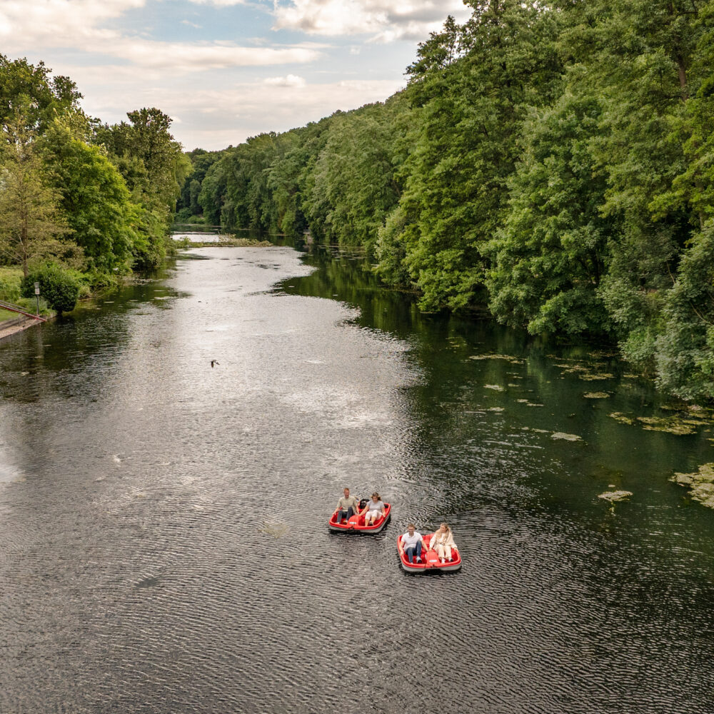 Luftaufnahme Kermsidahl mit zwei roten Treetbooten, in den Treetbooten sitzt jeweils ein Mann und eine Frau